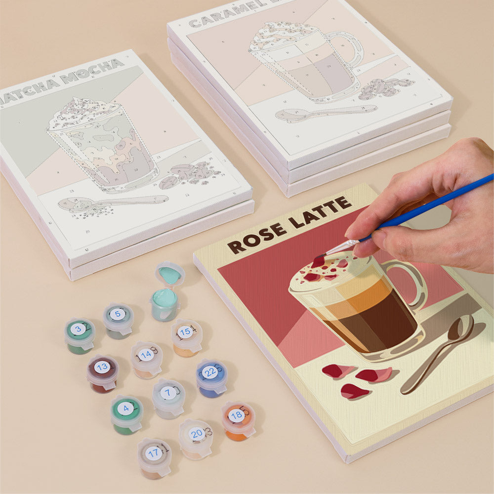 Painting one of the Latte Menu designs next to a stack of mini canvases