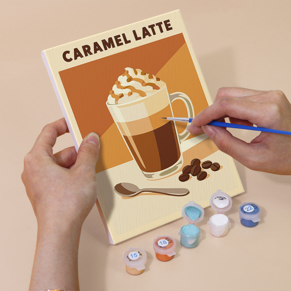 Hand holding a Latte Menu mini canvas while painting the details