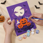 Hand holding a Lavender Hauntings mini canvas while painting the details