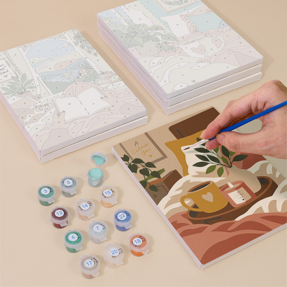 Painting one of the Lazy Sundays designs next to a stack of mini canvases