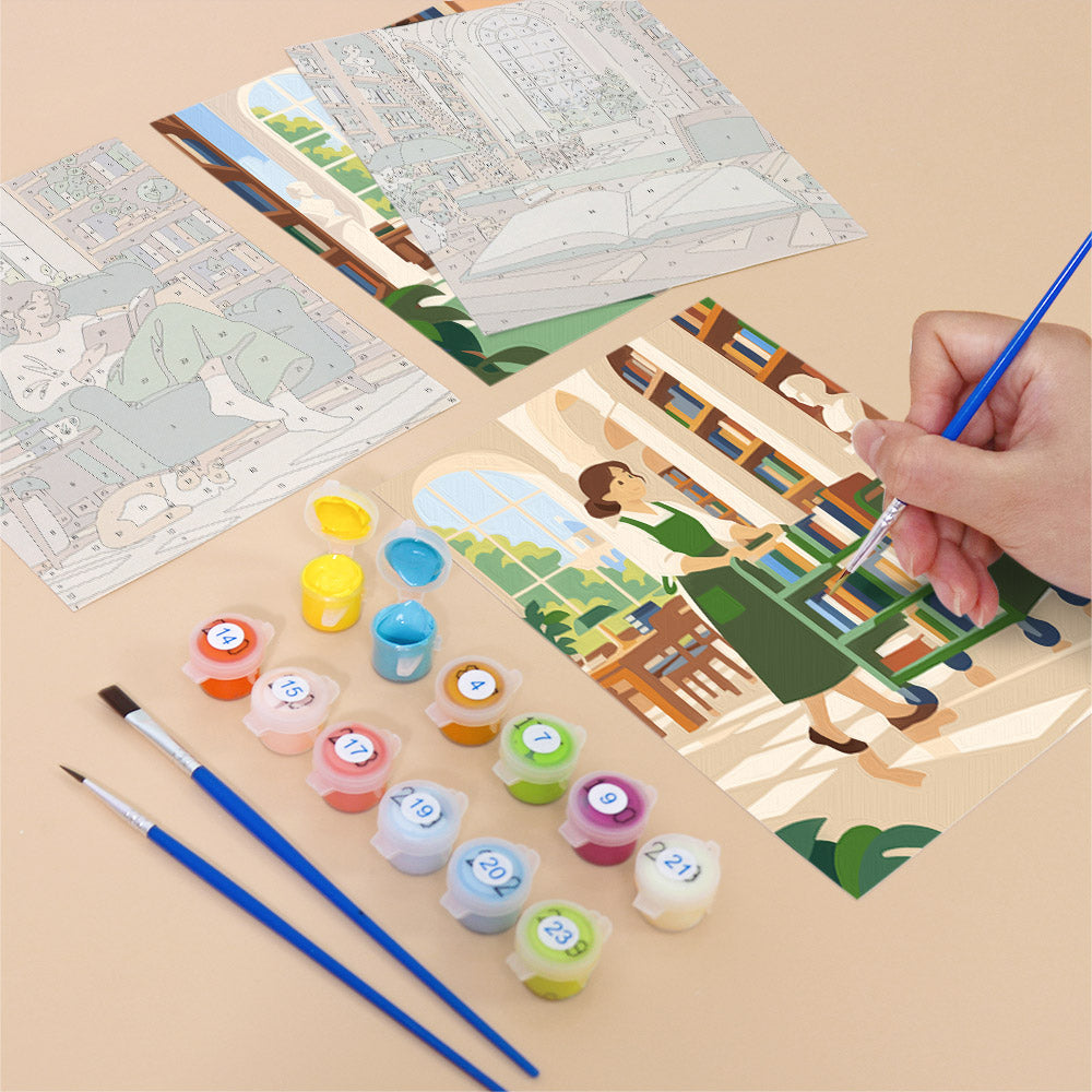 Filling in a Library Hours mini canvas with numbered acrylic paints and a fine brush