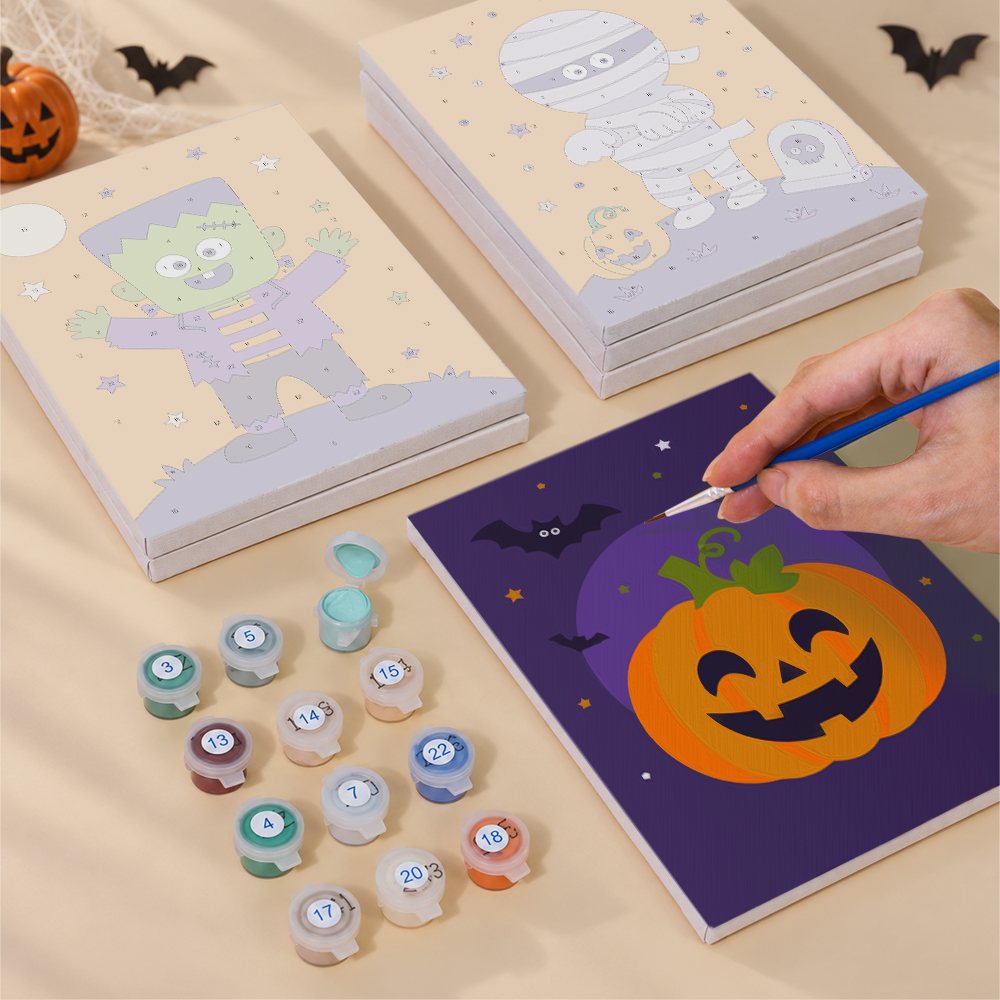 Painting one of the Little Monsters designs next to a stack of mini canvases