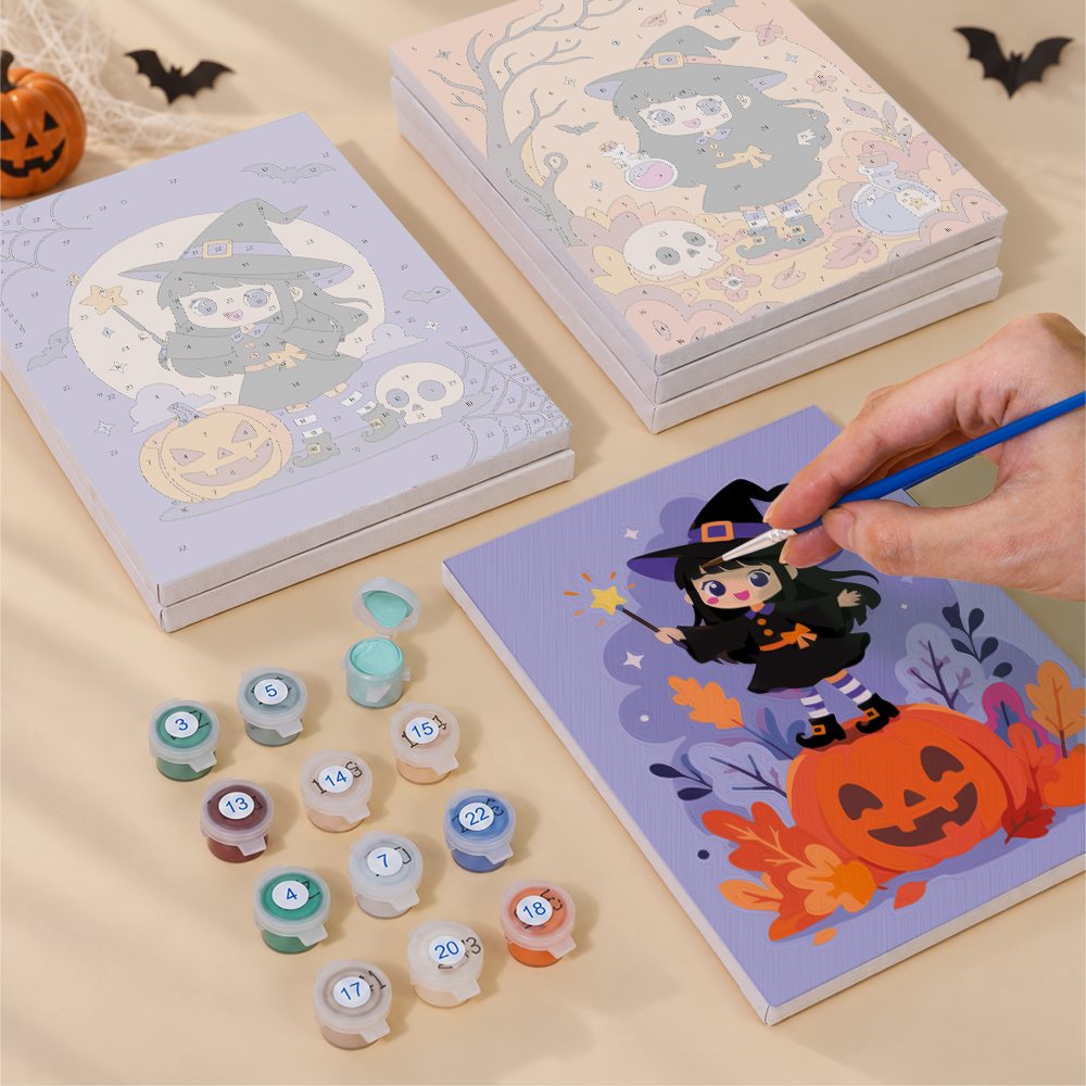 Painting one of the Little Witch Adventures designs next to a stack of mini canvases
