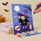 Painting a Little Witch Adventures mini canvas propped up beside numbered acrylic paints