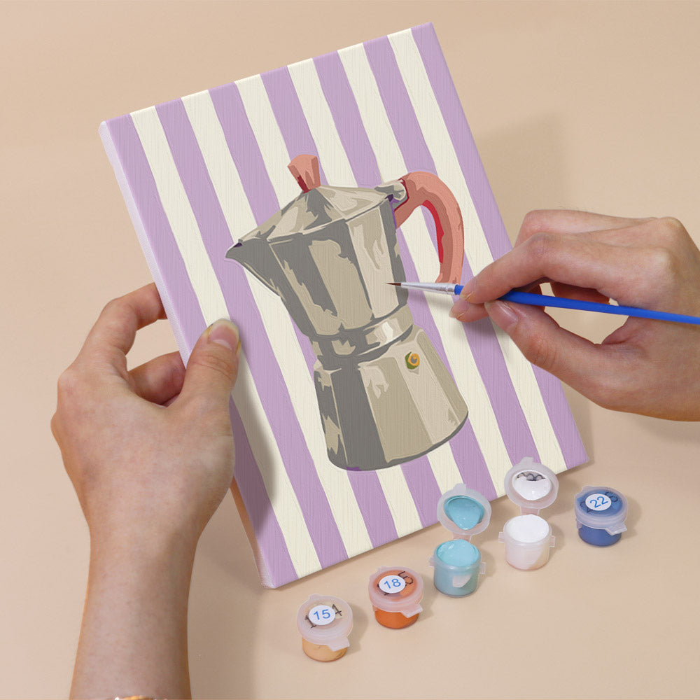 Hand holding a Market Stripes mini canvas while painting the details