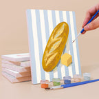 Painting a Market Stripes mini canvas propped up beside numbered acrylic paints
