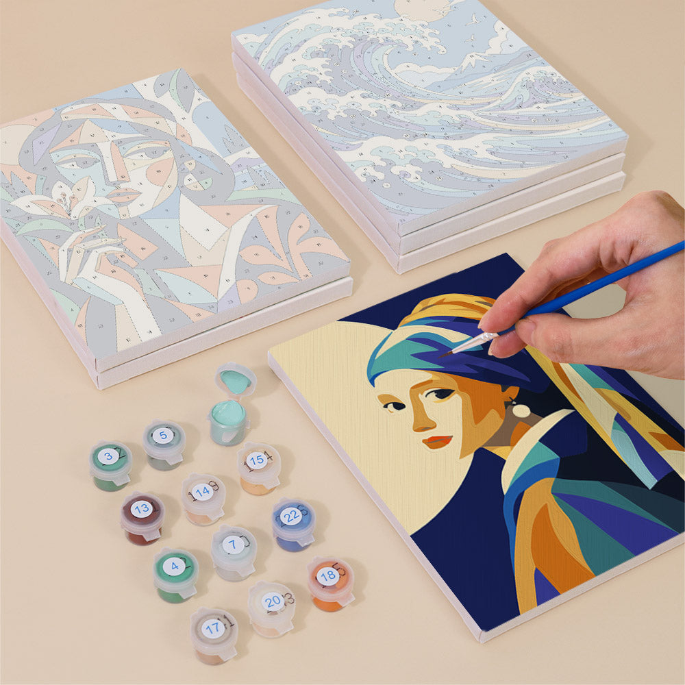 Painting one of the Masterpiece Remix designs next to a stack of mini canvases
