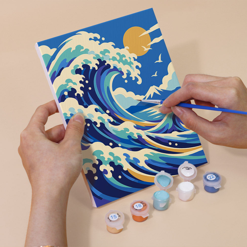 Hand holding a Masterpiece Remix mini canvas while painting the details