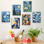 Six finished Masterpiece Remix mini paintings hung on a wall above a table