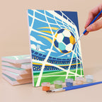 Painting a Matchday Magic mini canvas propped up beside numbered acrylic paints