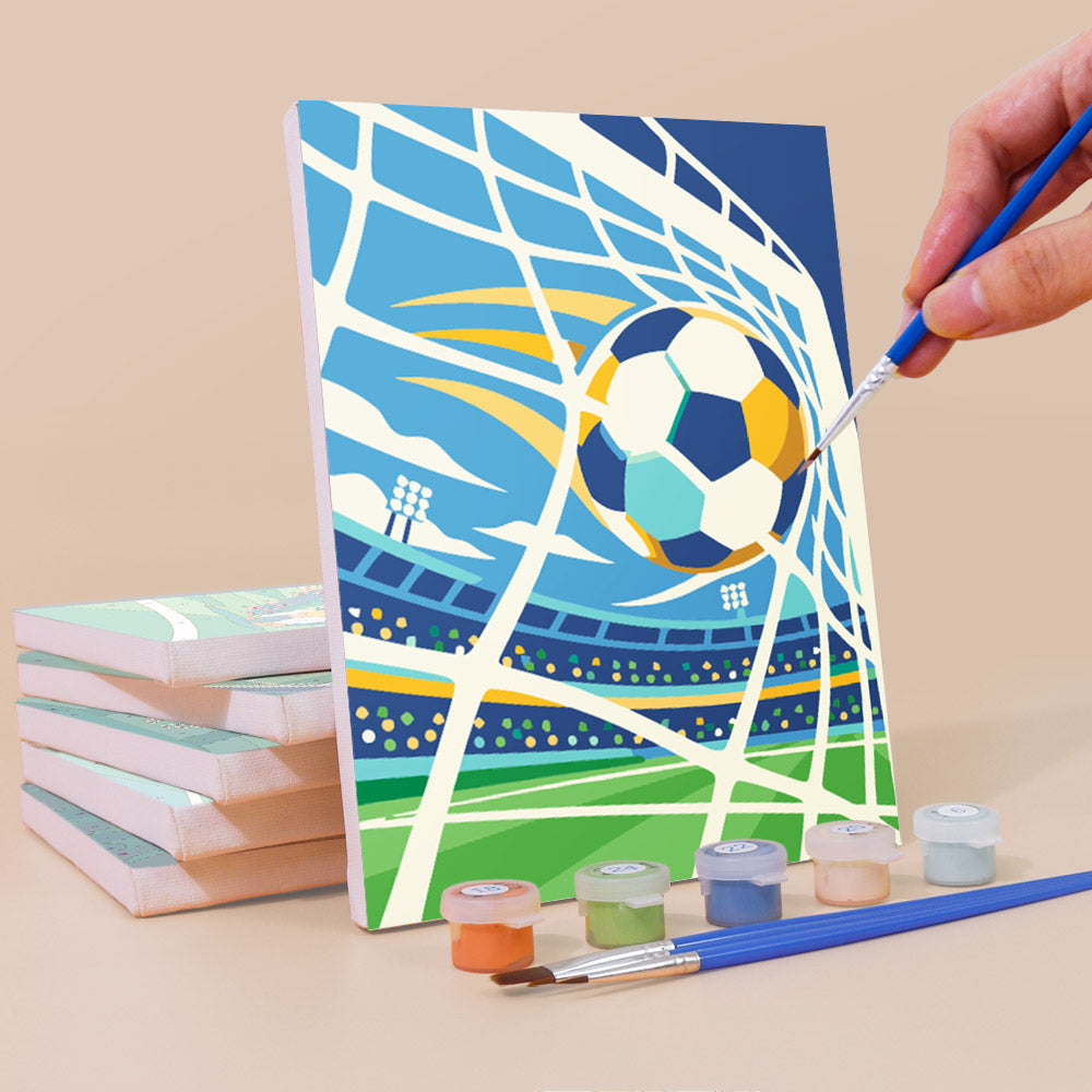 Painting a Matchday Magic mini canvas propped up beside numbered acrylic paints