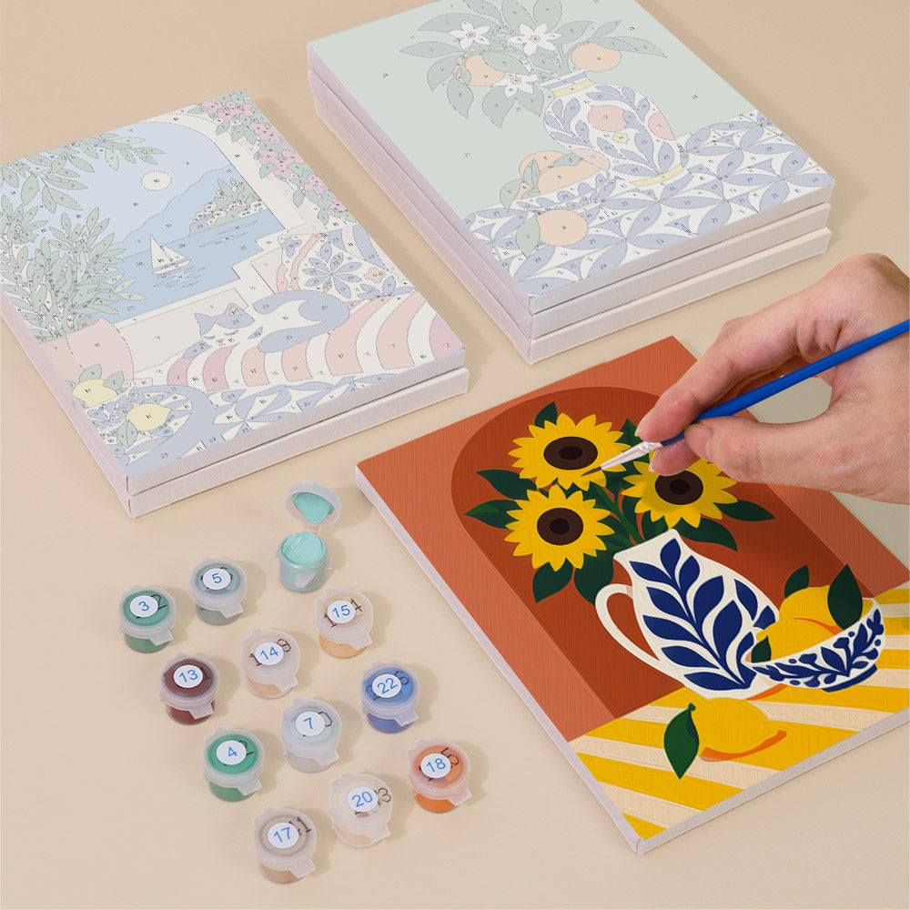 Painting one of the Mediterranean Summer designs next to a stack of mini canvases