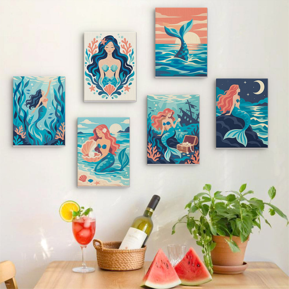 Six finished Mermaid Tales mini paintings hung on a wall above a table