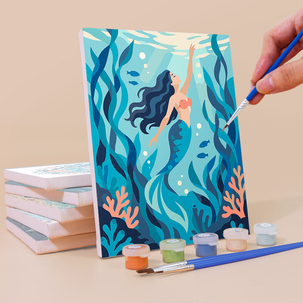 Painting a Mermaid Tales mini canvas propped up beside numbered acrylic paints