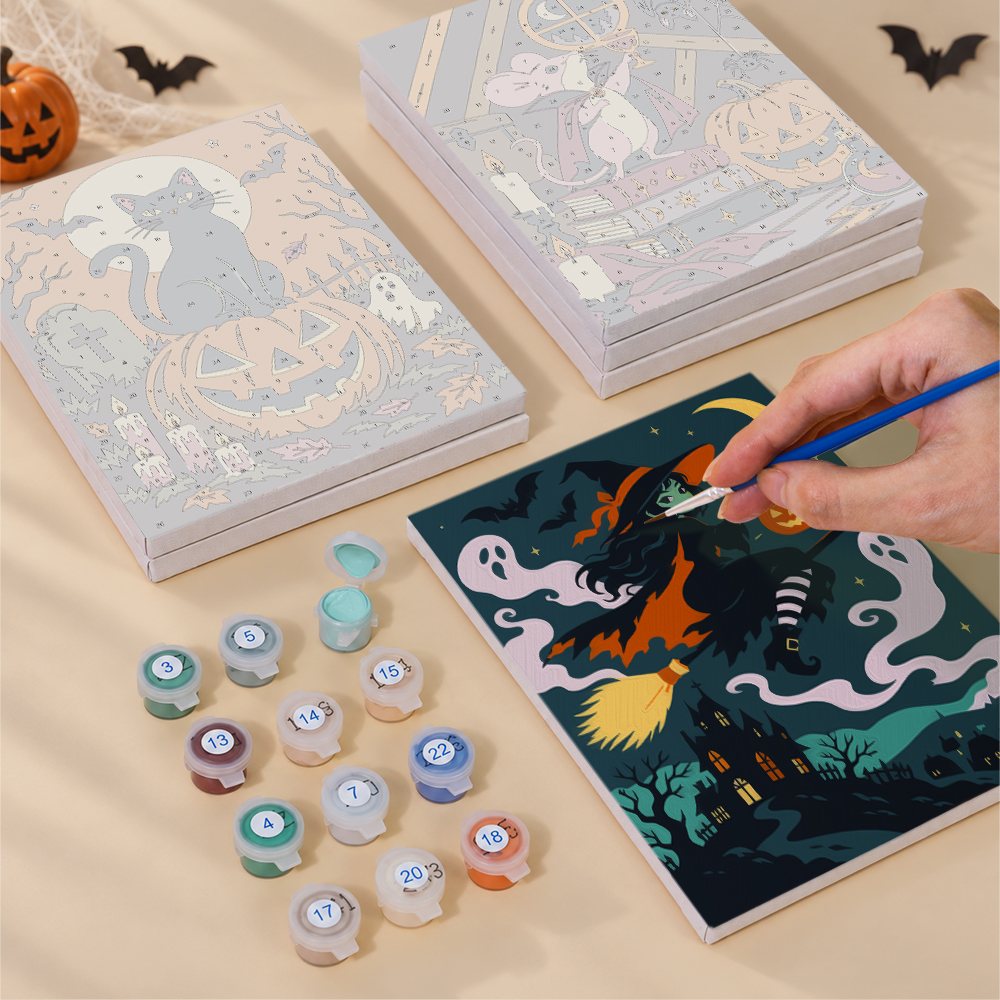Painting one of the Midnight Folk Tales designs next to a stack of mini canvases