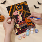 Hand holding a Midnight Folk Tales mini canvas while painting the details