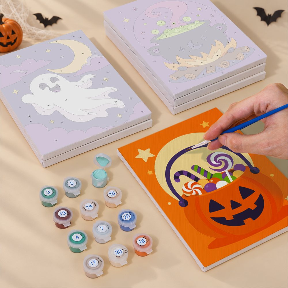 Painting one of the Midnight Friends designs next to a stack of mini canvases