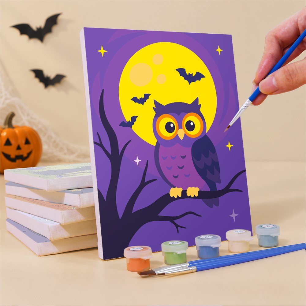 Painting a Midnight Friends mini canvas propped up beside numbered acrylic paints