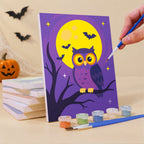 Painting a Midnight Friends mini canvas propped up beside numbered acrylic paints