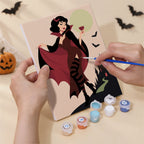 Hand holding a Midnight Monster Ball mini canvas while painting the details