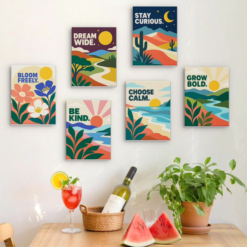 Six finished Mindful Mantras mini paintings hung on a wall above a table