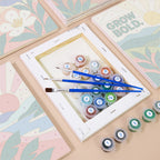 Numbered paint pots and brushes on a pre-stretched Mindful Mantras mini canvas