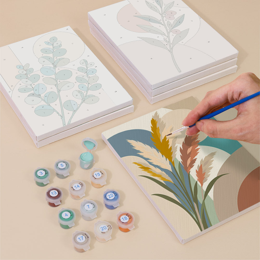 Painting one of the Modern Leaves designs next to a stack of mini canvases