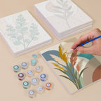 Painting one of the Modern Leaves designs next to a stack of mini canvases