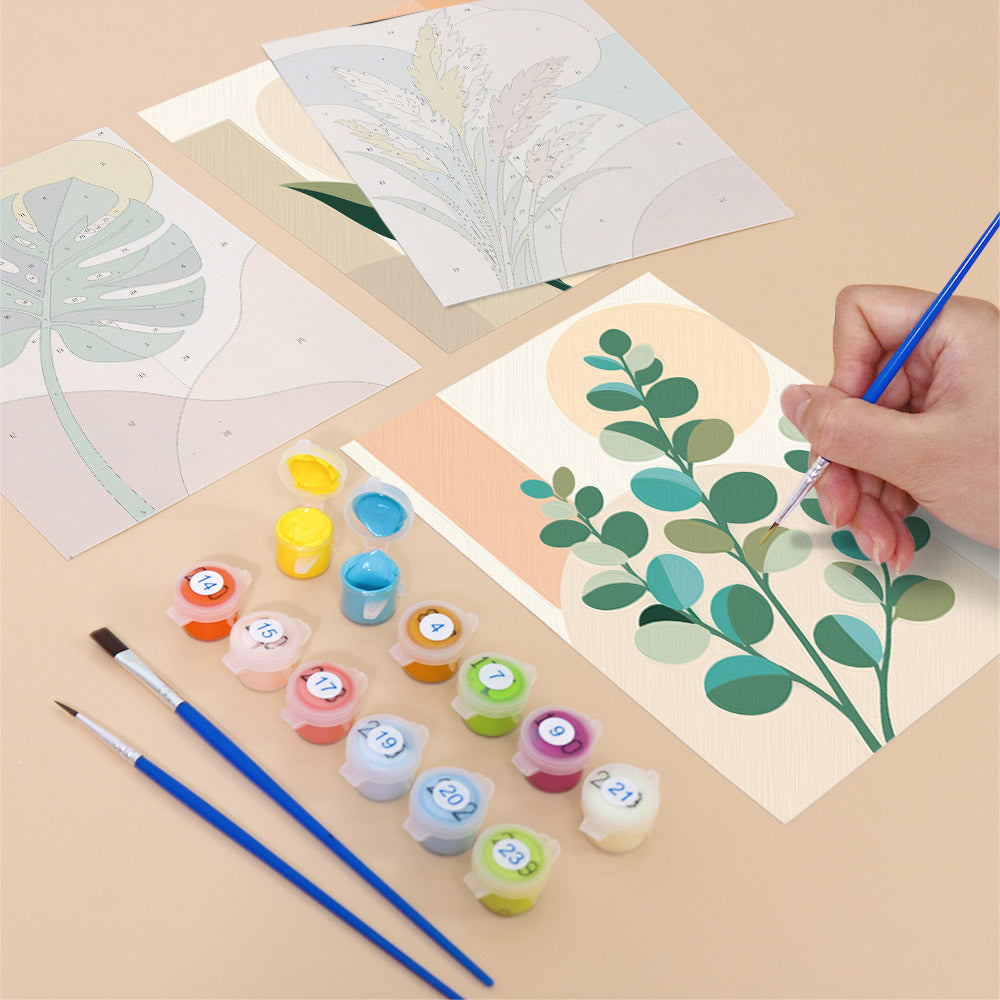 Filling in a Modern Leaves mini canvas with numbered acrylic paints and a fine brush