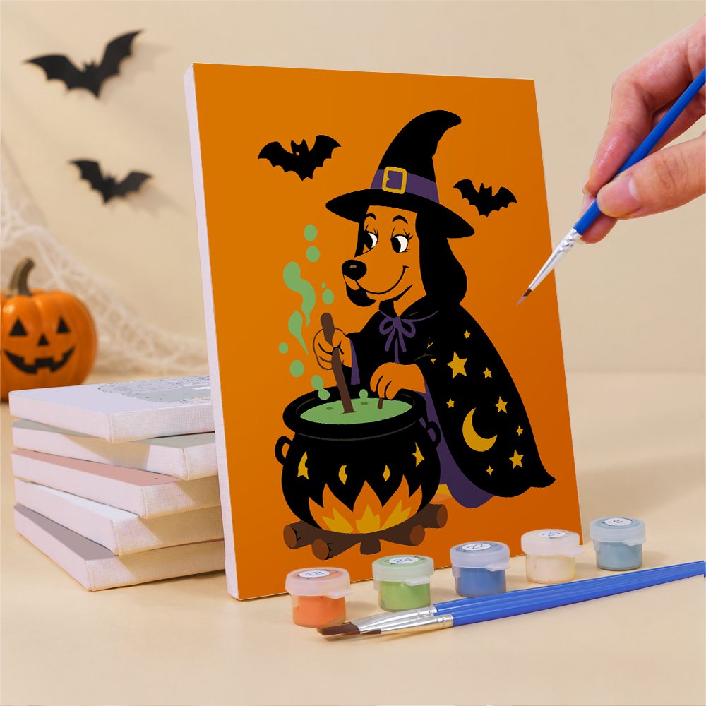 Painting a Monster Mash mini canvas propped up beside numbered acrylic paints