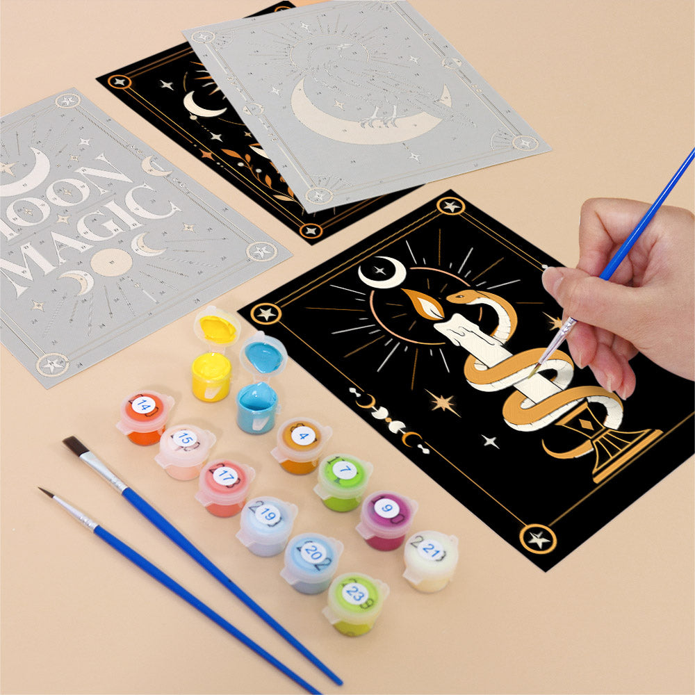 Filling in a Moon Magic mini canvas with numbered acrylic paints and a fine brush