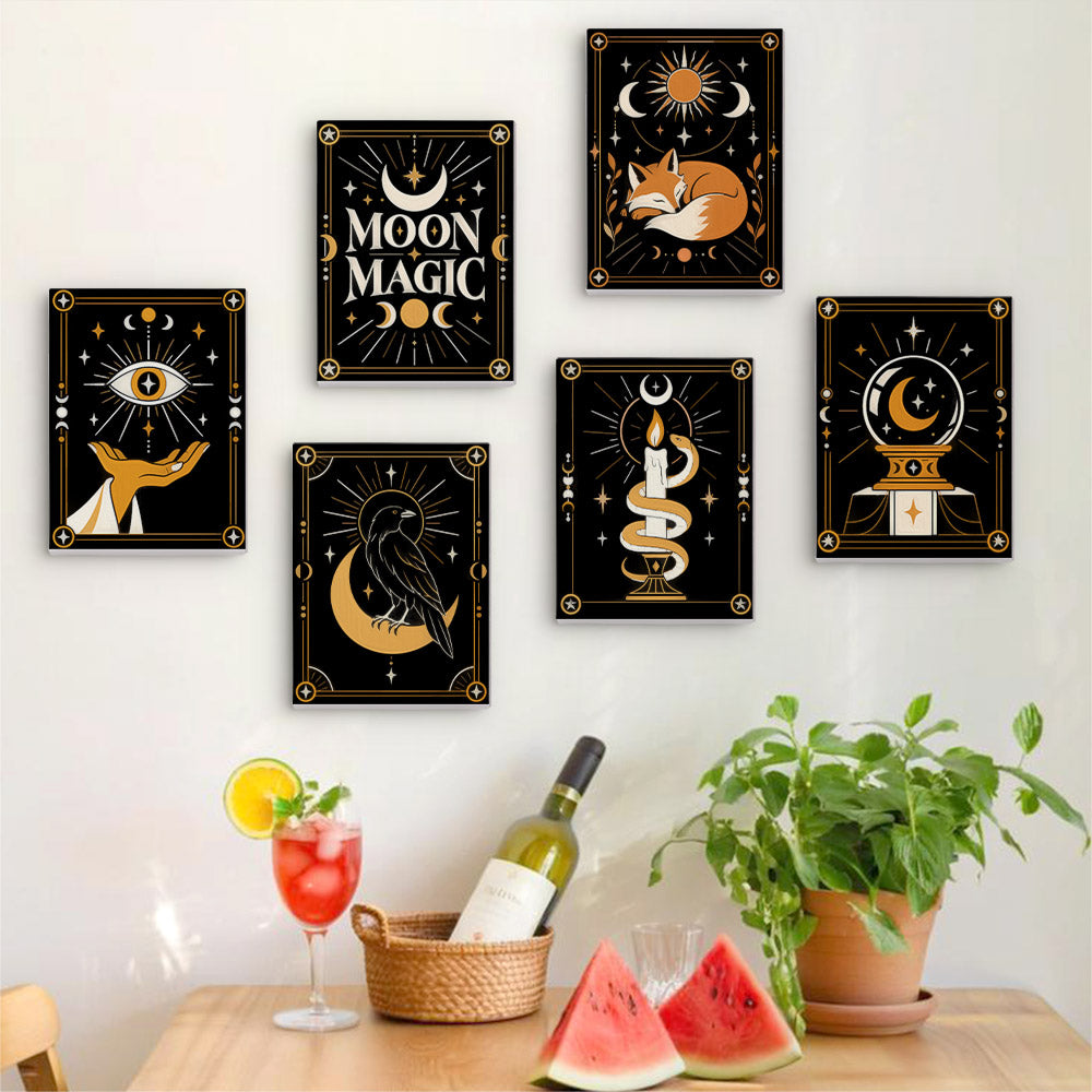 Six finished Moon Magic mini paintings hung on a wall above a table