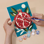 Hand holding a Moonlit Botanicals mini canvas while painting the details