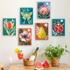 Six finished Moonlit Botanicals mini paintings hung on a wall above a table