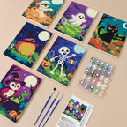 Painting one of the Moonlit Monster Meadows designs next to a stack of mini canvases