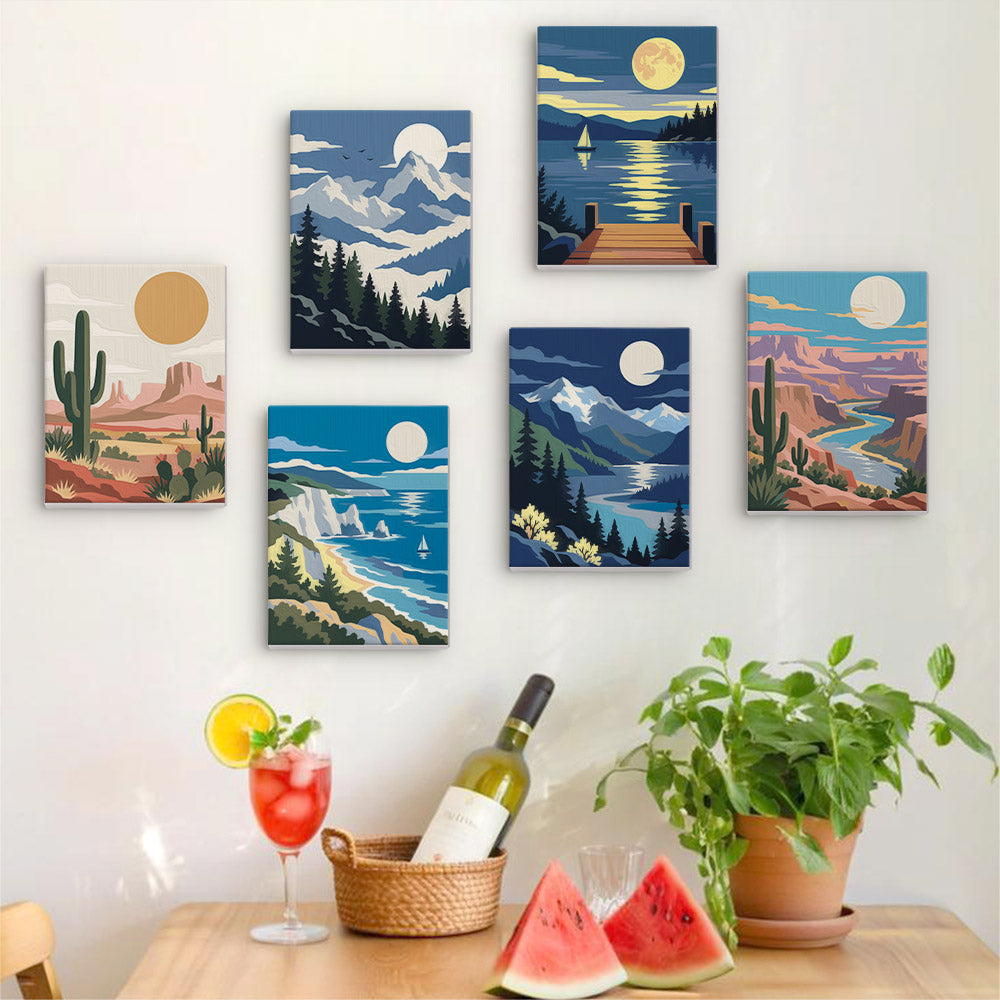 Six finished Moonlit Wilderness mini paintings hung on a wall above a table