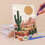 Painting a Moonlit Wilderness mini canvas propped up beside numbered acrylic paints