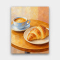 Morning Croissant paint by numbers kit of a cup of coffee and a golden croissant on a round wooden cafe table