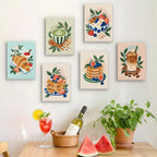 Six finished Morning Treats mini paintings hung on a wall above a table
