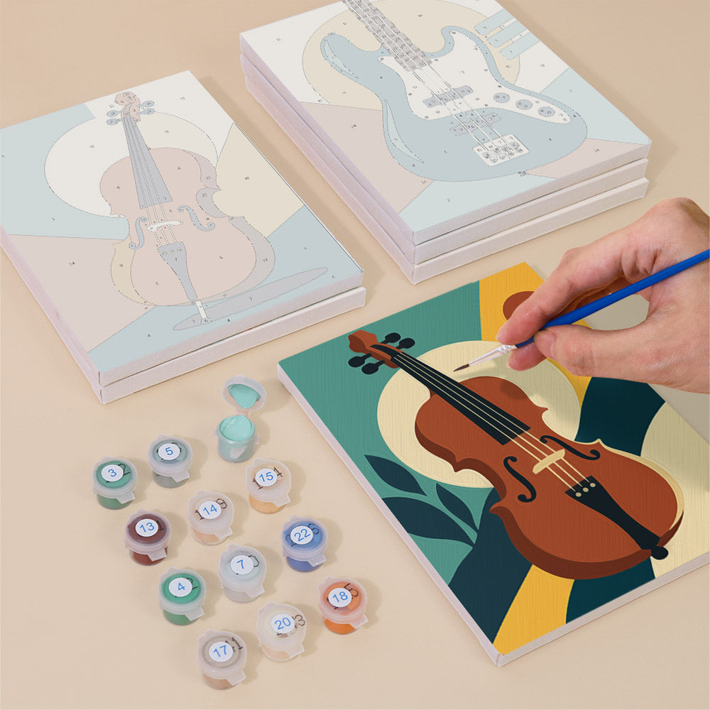 Painting one of the Music Makers designs next to a stack of mini canvases