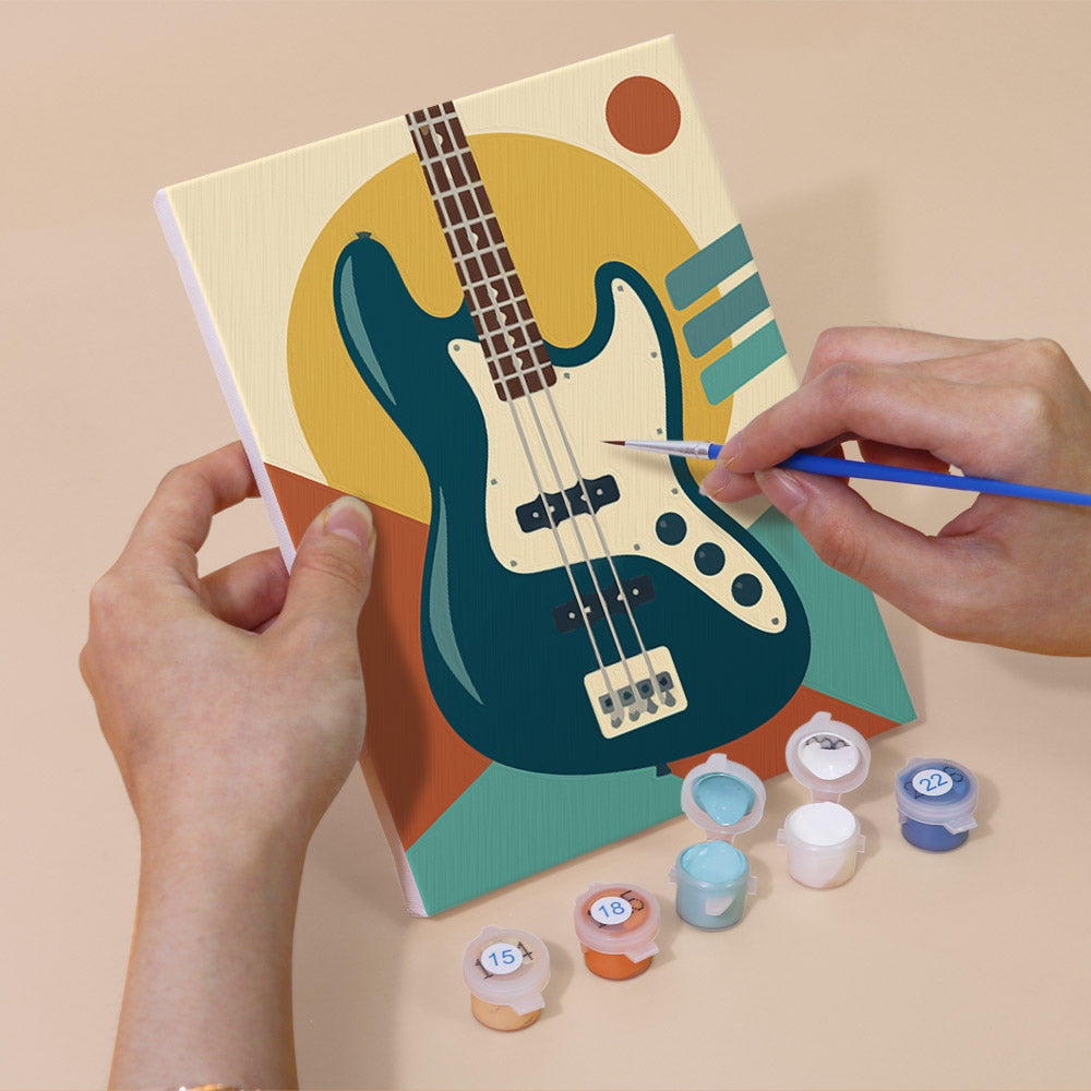 Hand holding a Music Makers mini canvas while painting the details