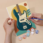 Hand holding a Music Makers mini canvas while painting the details