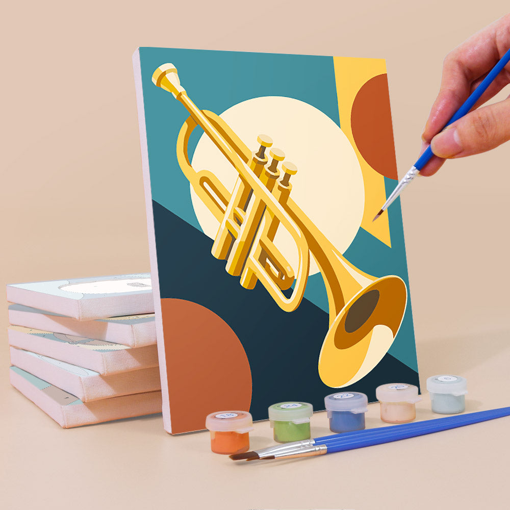 Painting a Music Makers mini canvas propped up beside numbered acrylic paints