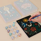 Painting one of the Mystic Folk designs next to a stack of mini canvases