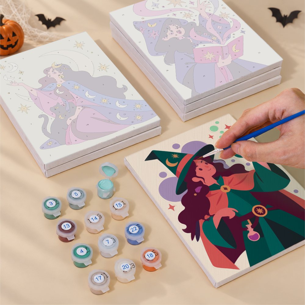 Painting one of the Mystic Moon Witches designs next to a stack of mini canvases