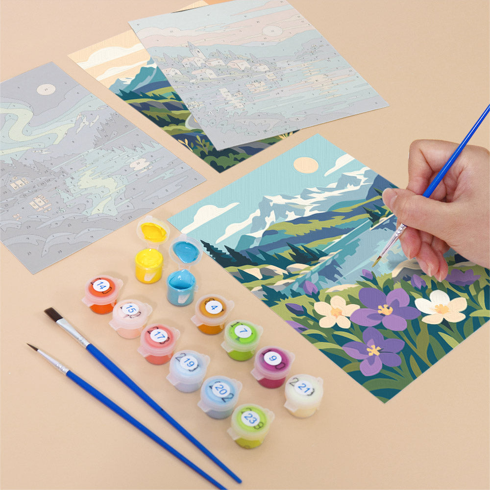 Filling in a Northern Wilds mini canvas with numbered acrylic paints and a fine brush