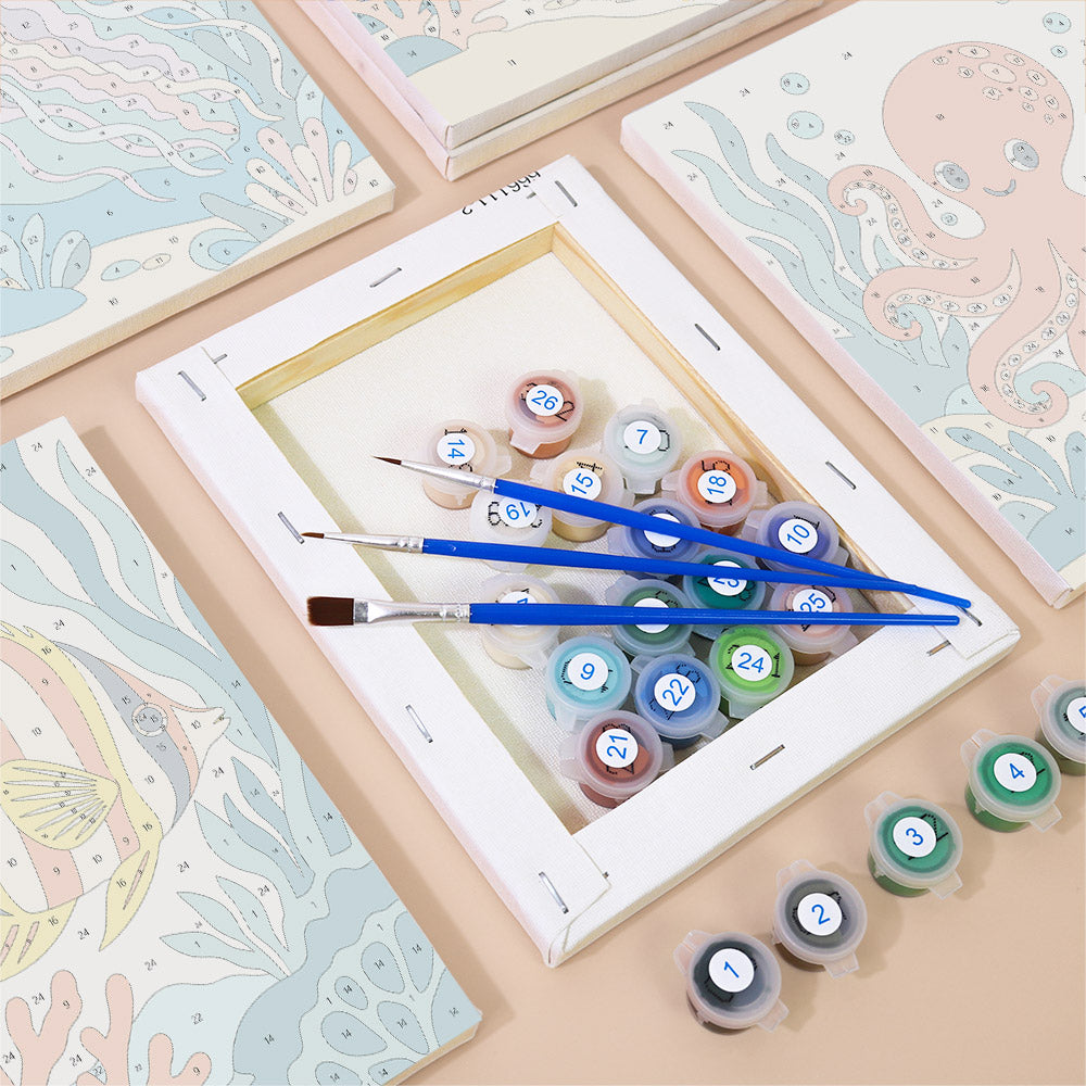 Numbered paint pots and brushes on a pre-stretched Ocean Friends mini canvas