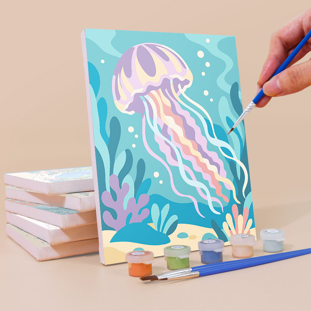 Painting an Ocean Friends mini canvas propped up beside numbered acrylic paints