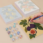 Painting one of the Orchard Harvest designs next to a stack of mini canvases