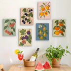 Six finished Orchard Harvest mini paintings hung on a wall above a table